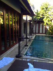 View of the fence along the pool and entrance to the living area to the left